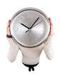 Foto: Girl holding clock at head height Girl holding clock at head height