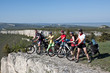 Photo: A group of five adults on bicycles in the countryside. A group of five adults on bicycles in the countryside.