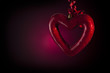 cuore bucato su sfondo nero con luce rossa