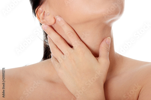 Photo: Young woman touching her throat - pain. Young woman touching her throat - pain.