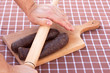 Raw sausages on stripe tablecloth