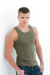sexy male model with pink green singlet on a seamless background sexy male model with pink green singlet on a seamless background