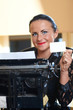 Young pretty woman sitting at a typewriter Young pretty woman sitting at a typewriter