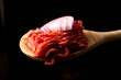 Minced beef on a wooden spoon