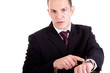 upset businessman pointing to the watch