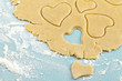 Making heart shaped shortbread cookies with cutters, dough