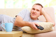 Smiling man watching television