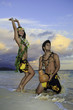 couple dancing hula by the ocean in hawaii