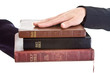 Photo: Swearing on a Stack of Bibles Hand on Top Isolated Background Swearing on a Stack of Bibles Hand on Top Isolated Background