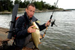 Photo: Fisherman just caught a fish Fisherman just caught a fish
