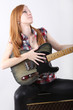 Cute girl with electric guitar isolated