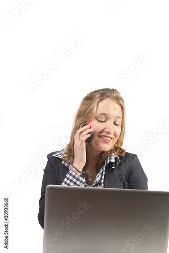 Photo: Woman behind laptop with phone Woman behind laptop with phone