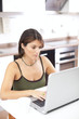 Modern woman reading e-mails at her breakfast