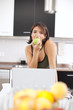 Modern woman reading e-mails at her breakfast