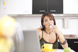 Modern woman reading e-mails at her breakfast