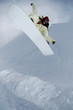 Jumping snowboarder in the mountains
