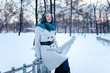 Portrait of beautiful young girl sitting on railings