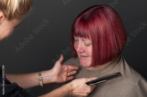 Photo: Hairdresser finishing a client's hair Hairdresser finishing a client's hair