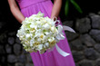 Bridesmaid holding bouquet.