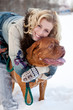 a  beautiful woman with a dog are in the winter park