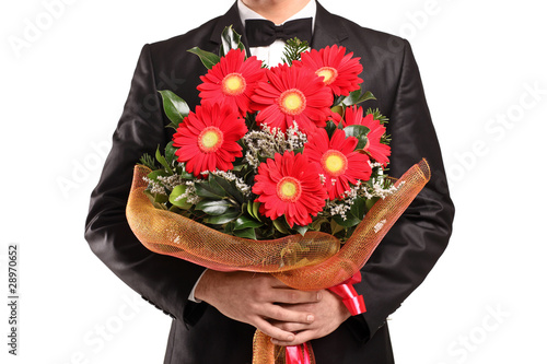 Photo: A man holding a large bouquet of flowers A man holding a large bouquet of flowers