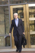 Photo: Businessman with briefcase coming out of office Businessman with briefcase coming out of office