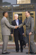 Photo: Three businessmen in front of their office building Three businessmen in front of their office building