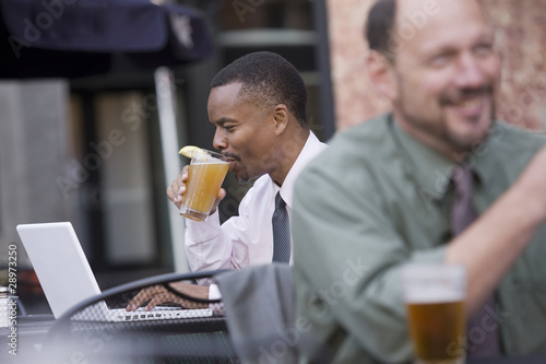 Photo: Two men working at a cafe Two men working at a cafe