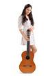 Young beautiful brunette girl in white chemise with acoustic gui
