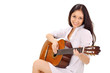 Young beautiful smiling brunette lady in white chemise playing a