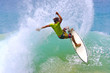 surfer hitting wave lip creates a water curtain spray
