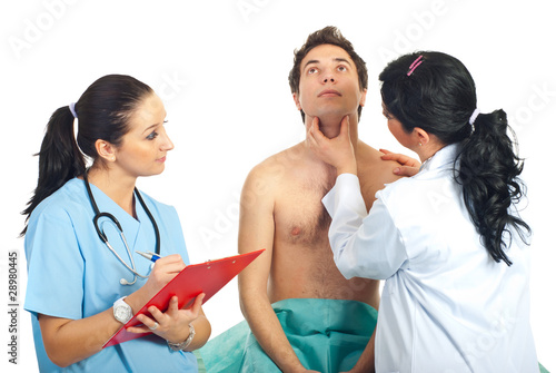 Photo: Physician woman examine neck male patient Physician woman examine neck male patient