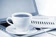 Cappuccino cup with laptop and newspaper. Toned Cappuccino cup with laptop and newspaper. Toned