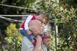 A grandfather carrying his granddaughter, smiling