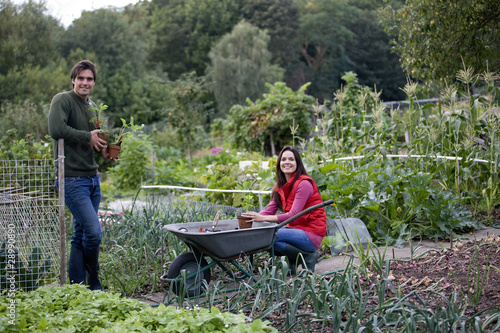 Photo: A young couple working on an allotment A young couple working on an allotment