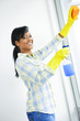 Foto: Smiling woman cleaning windows Smiling woman cleaning windows