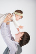 The happy father plays with the small daughter