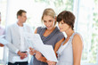Women reading business reports