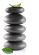 Spa stones with green leaves on a white background.