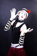 Theatrical mime in white hat with red flower Theatrical mime in white hat with red flower