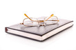 Notebook with glasses isolated on white