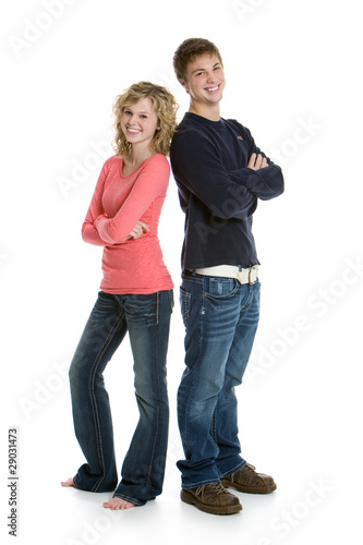 Photo: Teenage couple standing back to back with arms crossed Teenage couple standing back to back with arms crossed