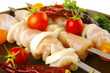 fresh raw chicken kebabs on plate