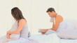 Man reading a book while his sad wife is thinking