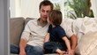 Attentive father watching tv with his son