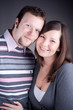 Portrait of a beautiful young couple hugging each other against Portrait of a beautiful young couple hugging each other against