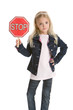 Pretty little girl holding a stop sign