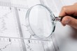 woman’s hand holding a magnifying glass woman’s hand holding a magnifying glass