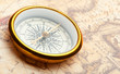 Old compass on ancient map