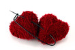 Photo: Two heart shaped clews pinned with huge pin on white background Two heart shaped clews pinned with huge pin on white background